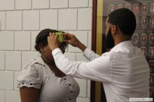 woman looking up as a sticky note is placed on her forehead