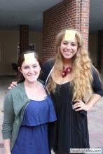two women posing together with sticky notes on their forehead