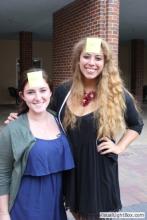 two women posing together with sticky notes on their forehead