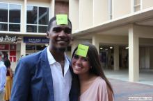 man and a woman posing together with sticky notes on their forehead