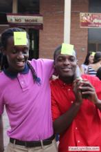 two men posing together with sticky notes on their forehead