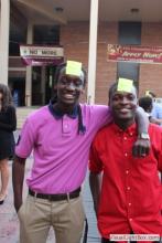two men posing together with sticky notes on their forehead