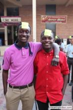 two men posing together with sticky notes on their forehead