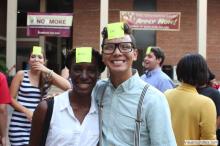 man and a woman posing together with sticky notes on their forehead