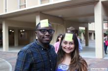 man and a woman posing together with sticky notes on their forehead