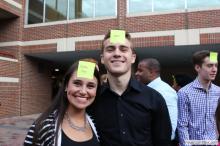 man and a woman posing together with sticky notes on their forehead
