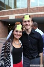 man and a woman posing together with sticky notes on their forehead