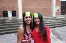 two women posing together with sticky notes on their forehead